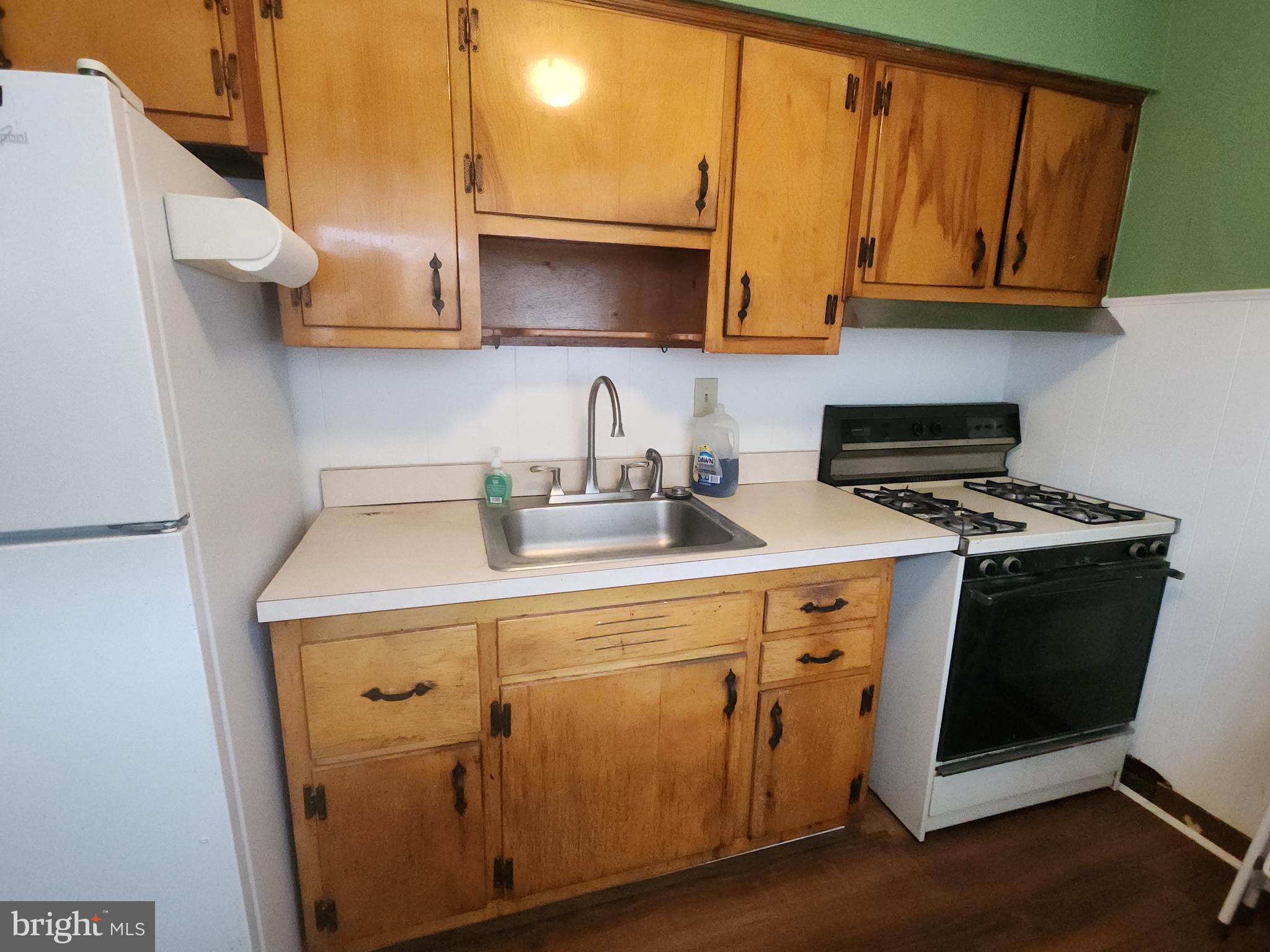 8409 Loretto Avenue Philadelphia, PA 19152 - Photo 6 of 22 a kitchen with sink a microwave and cabinets