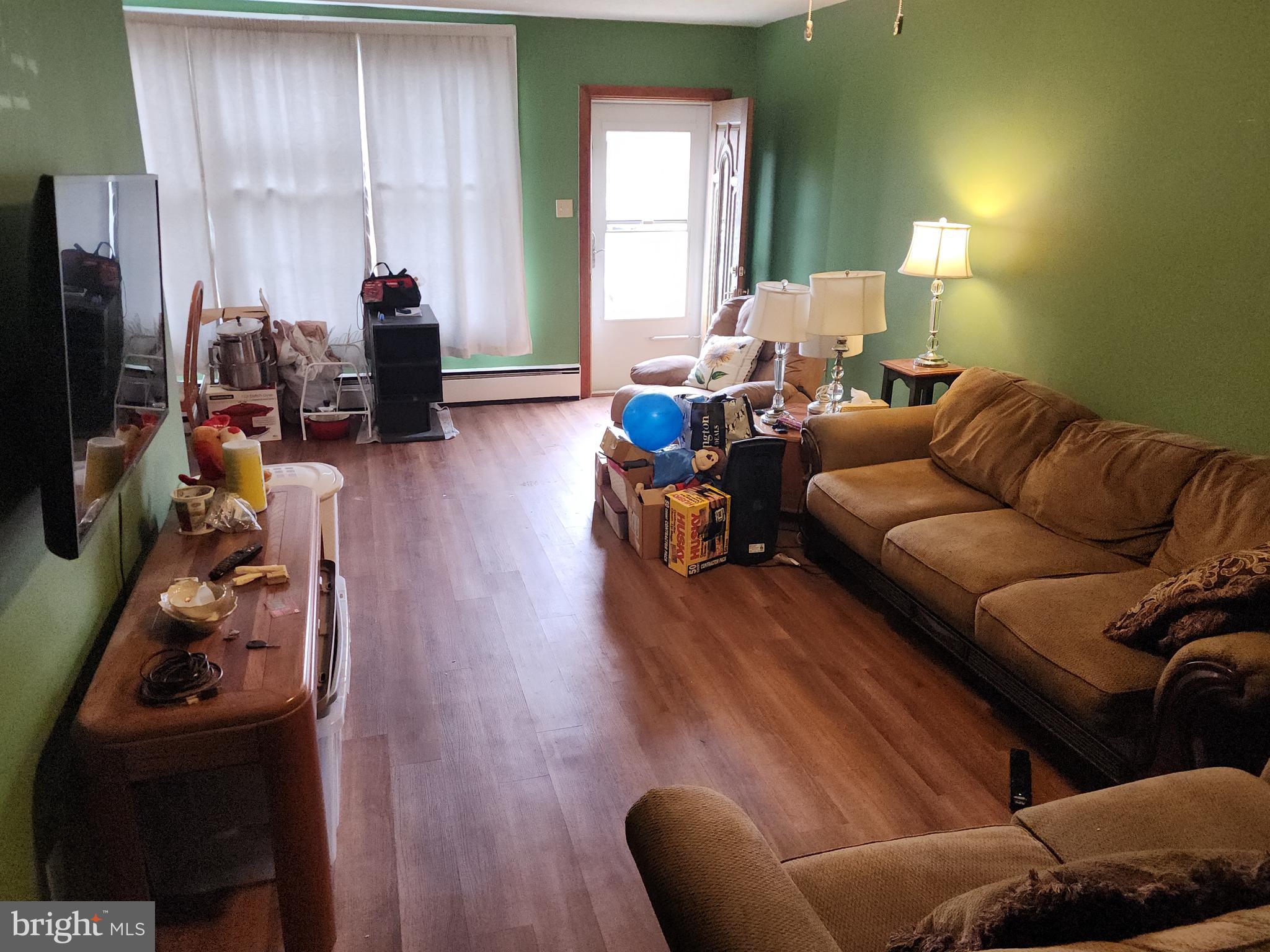 8409 Loretto Avenue Philadelphia, PA 19152 - Photo 7 of 22 a living room with furniture a flat screen tv and a window