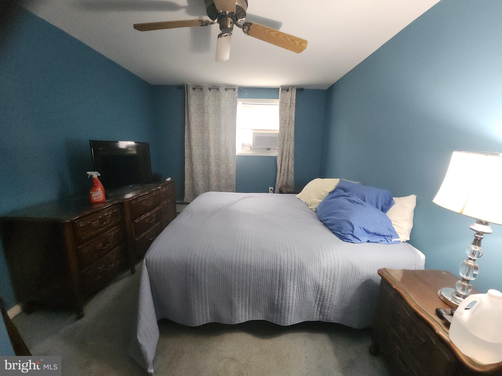 8409 Loretto Avenue Philadelphia, PA 19152 - Photo 9 of 22 a bedroom with a bed and a flat tv screen on a dresser