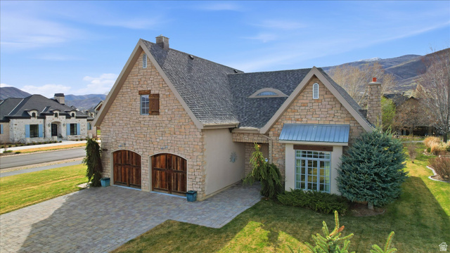 930 Price Farm Court Midway, UT 84049 - Photo 1 of 42 View of front of house with stone and stucco a mountain view, front yard, and garage