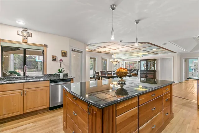 a kitchen with stainless steel appliances granite countertop a stove and a sink
