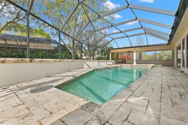 a large white kitchen with a lot of counter space and wooden floor