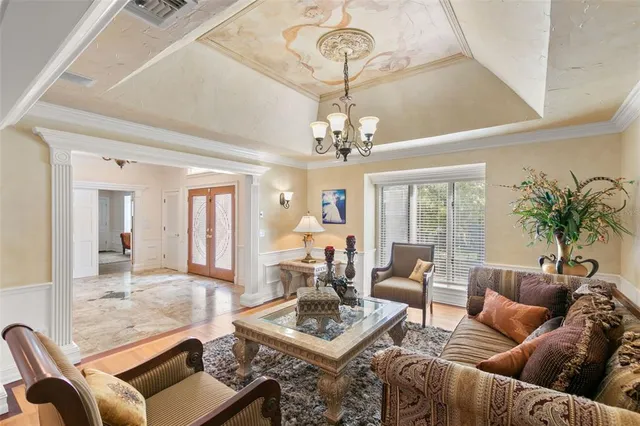 a living room with furniture and a chandelier