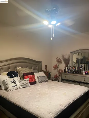 a bedroom with bed and cabinets