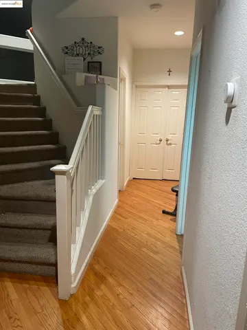 a view of a hallway with wooden floor and entryway