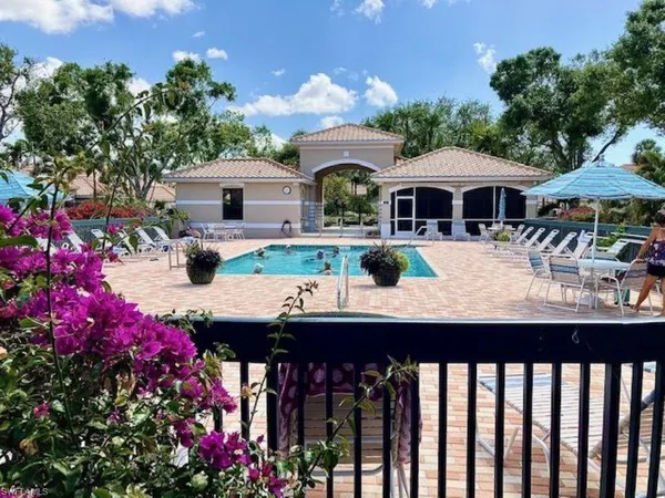 a sign that is sitting in front of a bunch of flowers