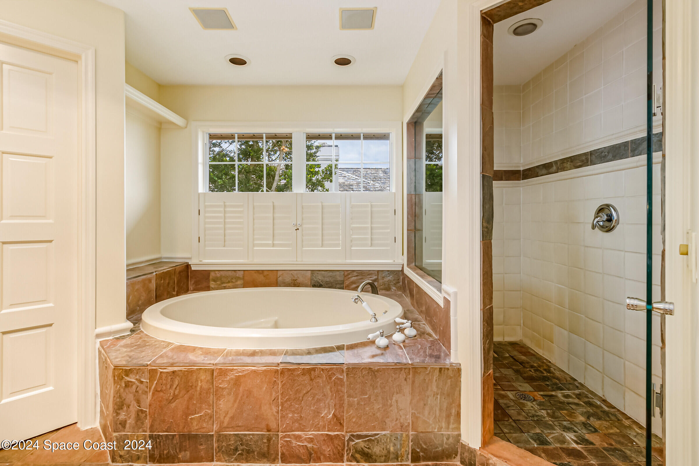 1630 Pine Street Melbourne Beach, FL 32951 - Photo 13 of 54 a bath tub sitting in a bathroom next to a window