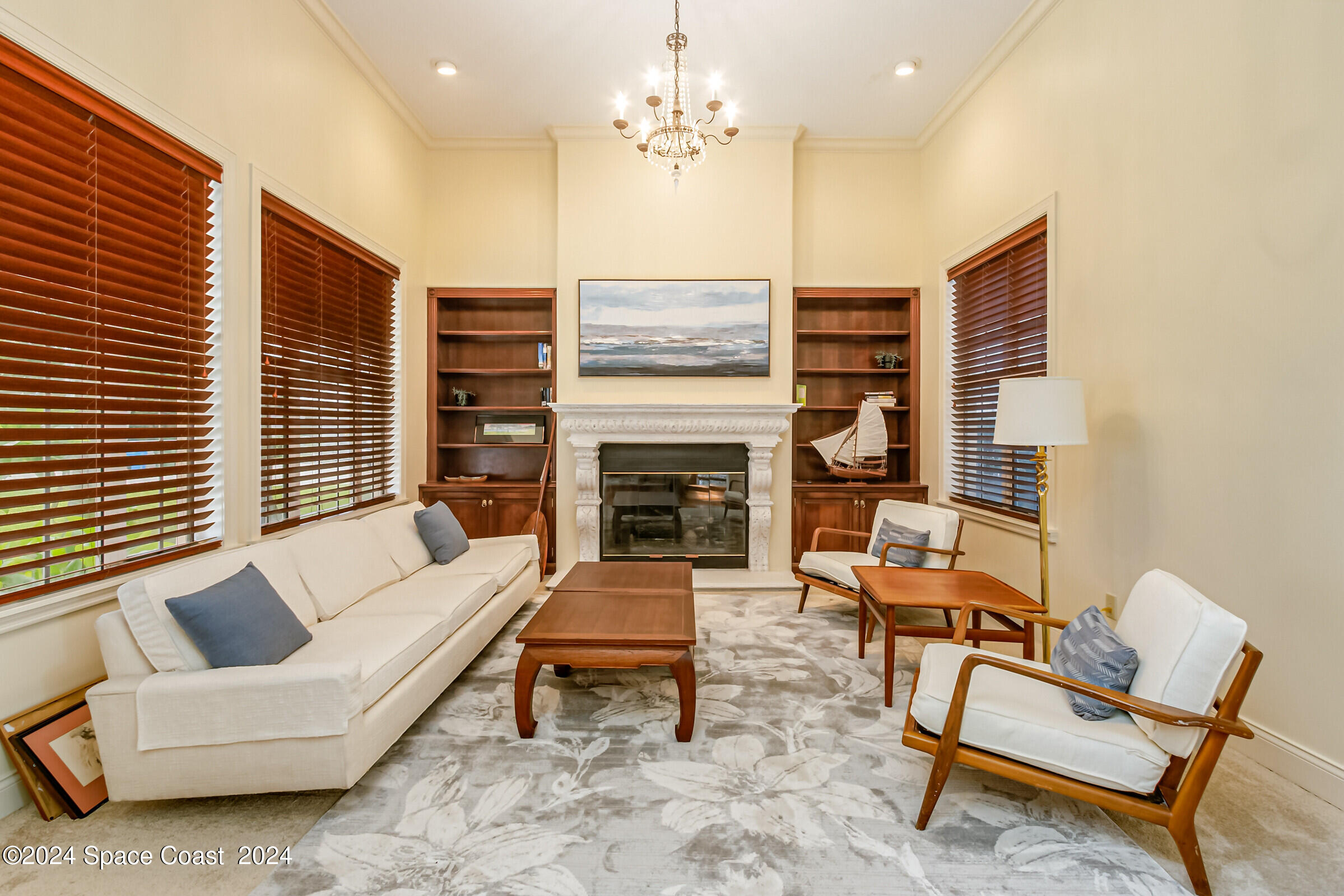 1630 Pine Street Melbourne Beach, FL 32951 - Photo 18 of 54 a living room with furniture a fireplace and a flat screen tv
