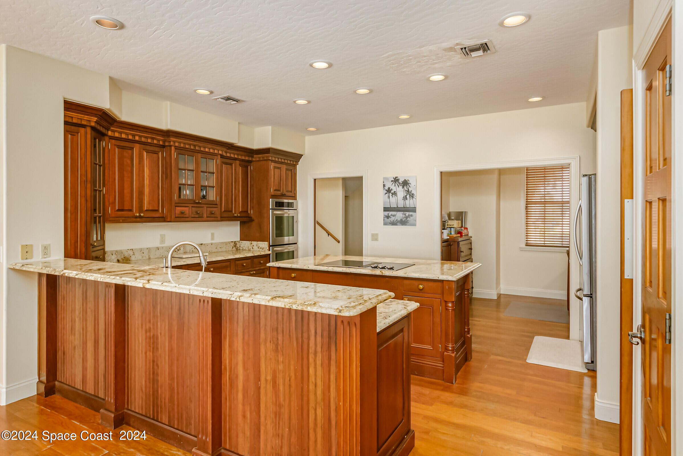 1630 Pine Street Melbourne Beach, FL 32951 - Photo 21 of 54 a large kitchen with stainless steel appliances a large counter top a sink and a refrigerator