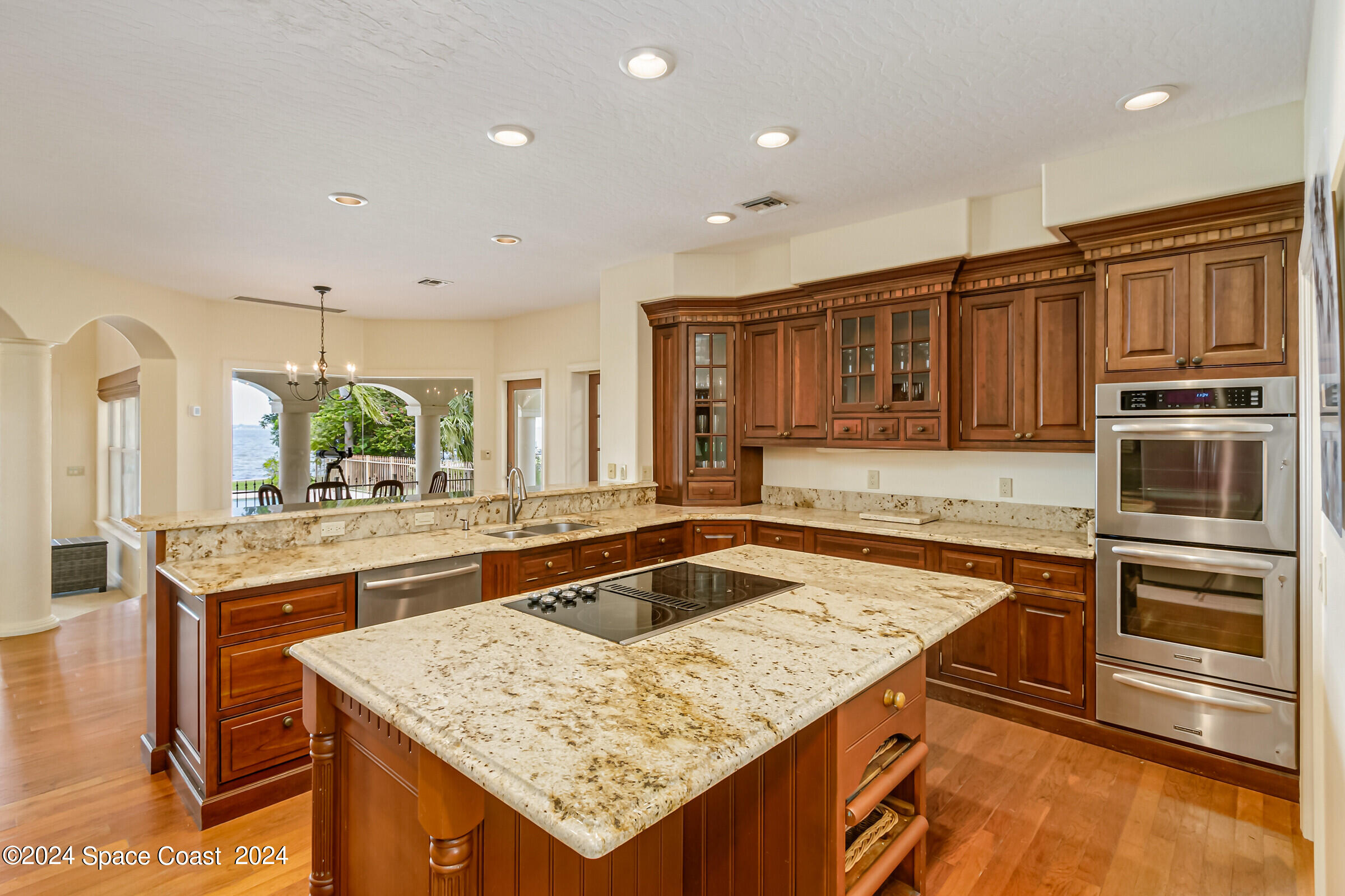 1630 Pine Street Melbourne Beach, FL 32951 - Photo 22 of 54 a kitchen with kitchen island granite countertop a sink and counter space
