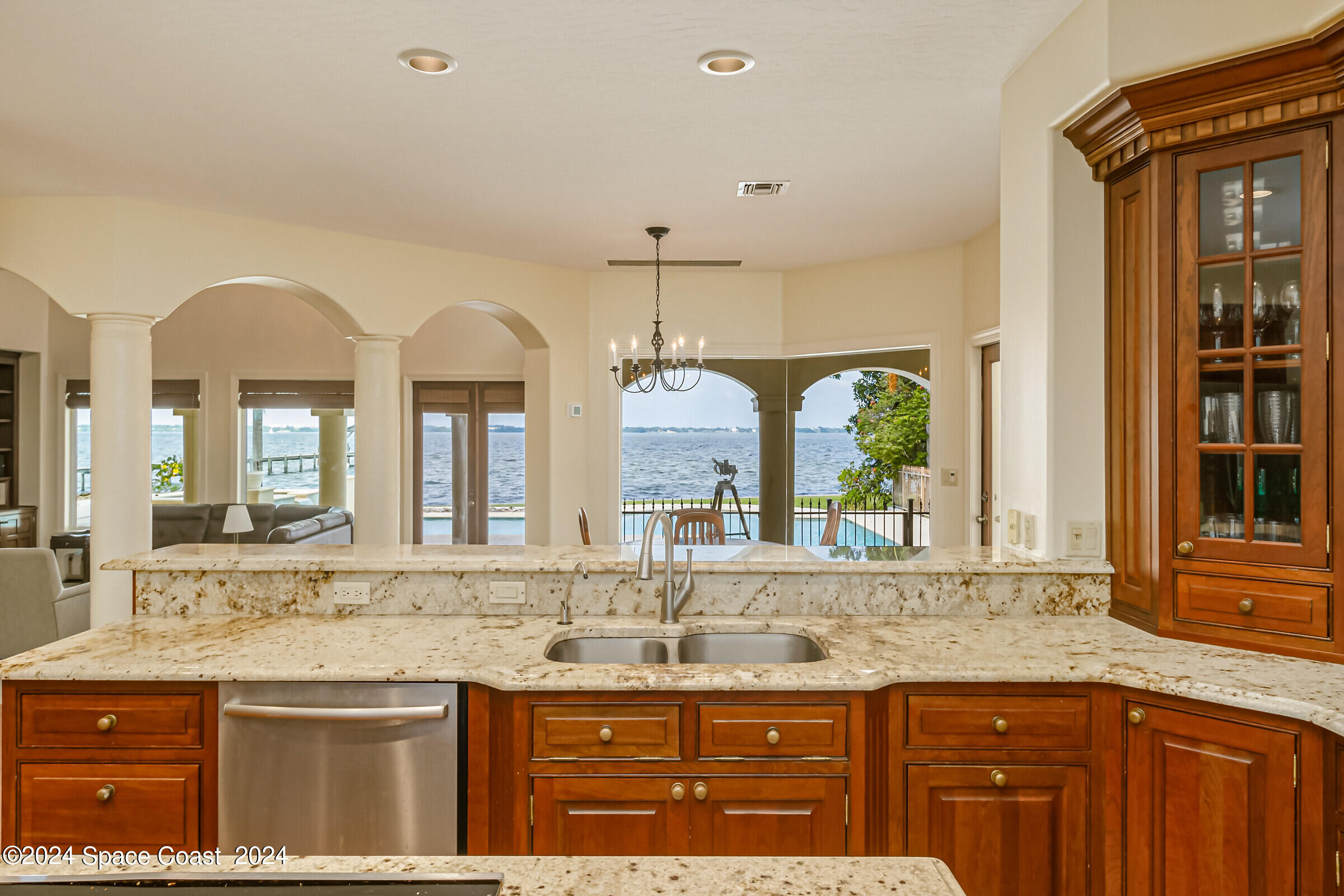 1630 Pine Street Melbourne Beach, FL 32951 - Photo 23 of 54 a bathroom with a granite countertop sink and a large mirror