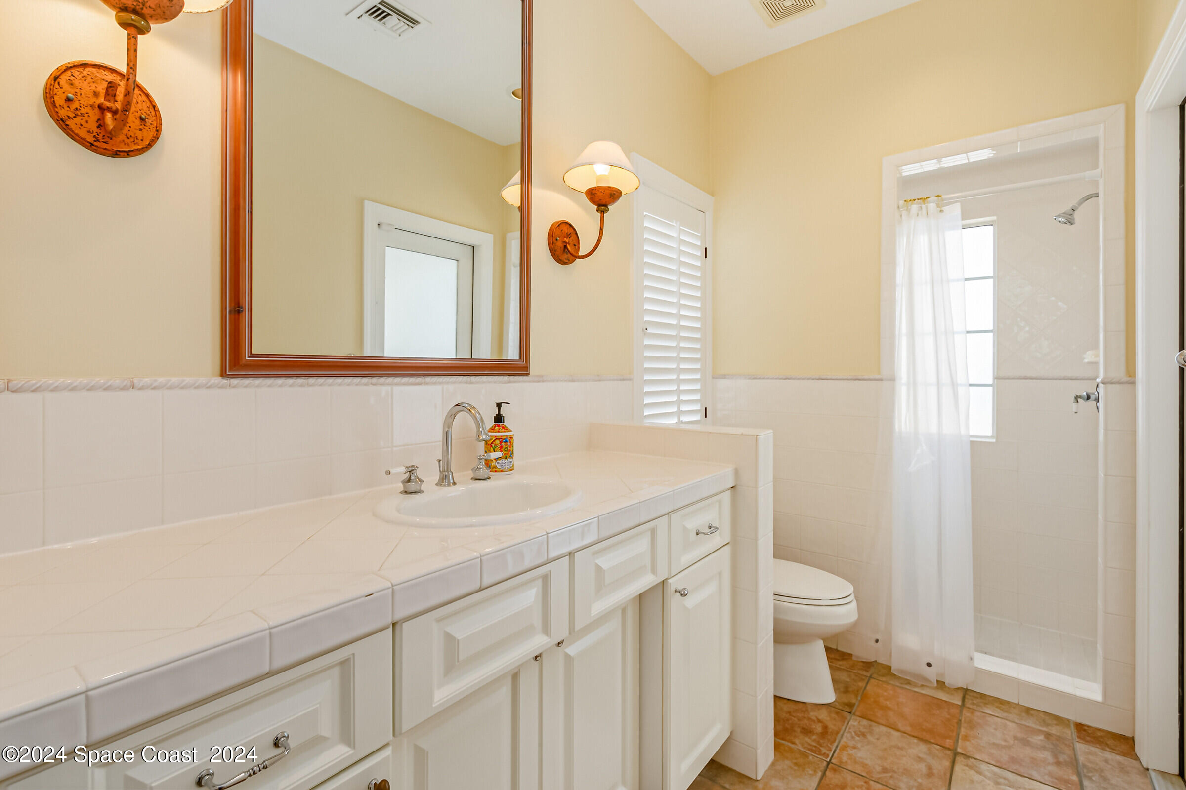 1630 Pine Street Melbourne Beach, FL 32951 - Photo 30 of 54 a bathroom with a sink a toilet and shower