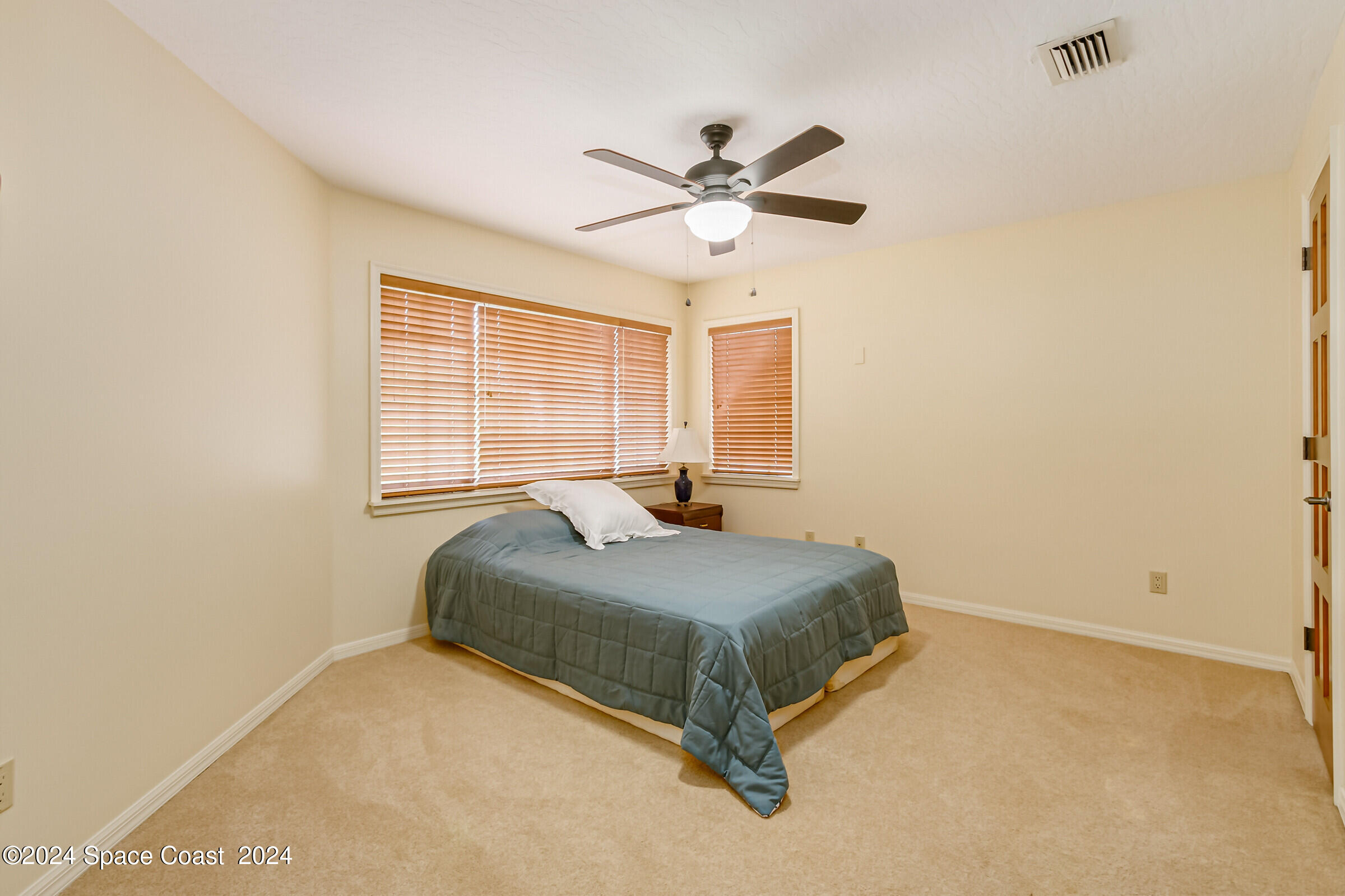 1630 Pine Street Melbourne Beach, FL 32951 - Photo 33 of 54 a bedroom with a bed and window