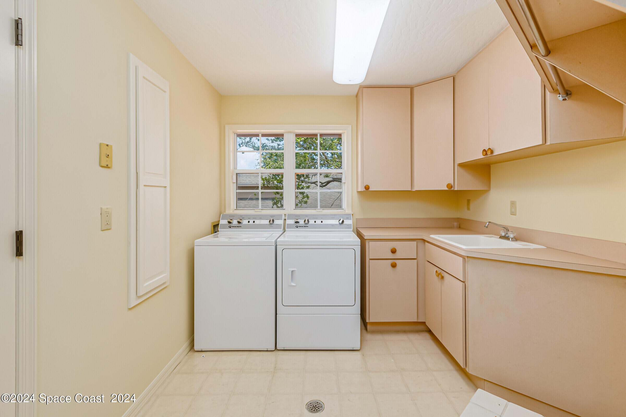 1630 Pine Street Melbourne Beach, FL 32951 - Photo 35 of 54 a utility room with cabinets washer and dryer