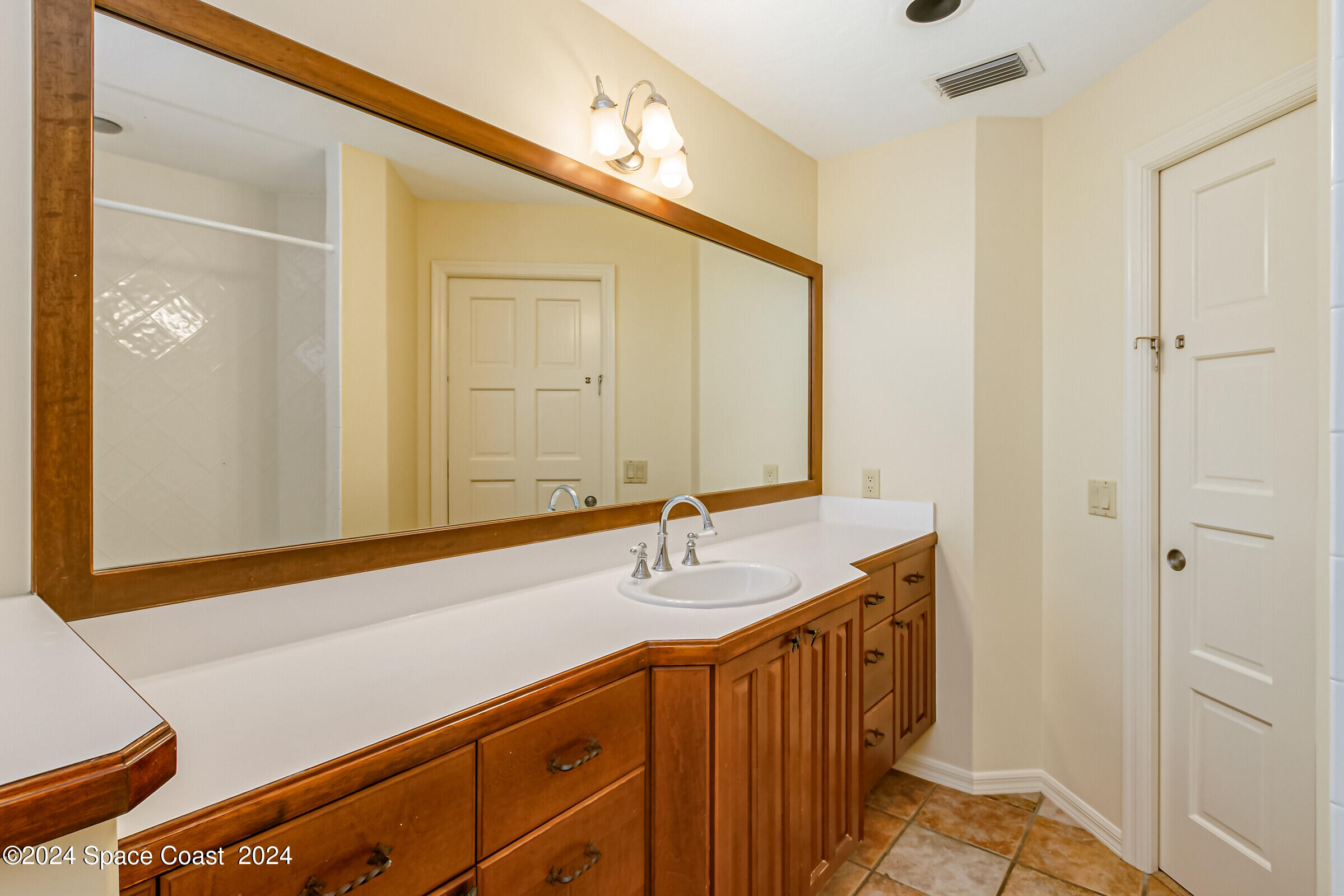 1630 Pine Street Melbourne Beach, FL 32951 - Photo 36 of 54 a bathroom with a sink and a mirror