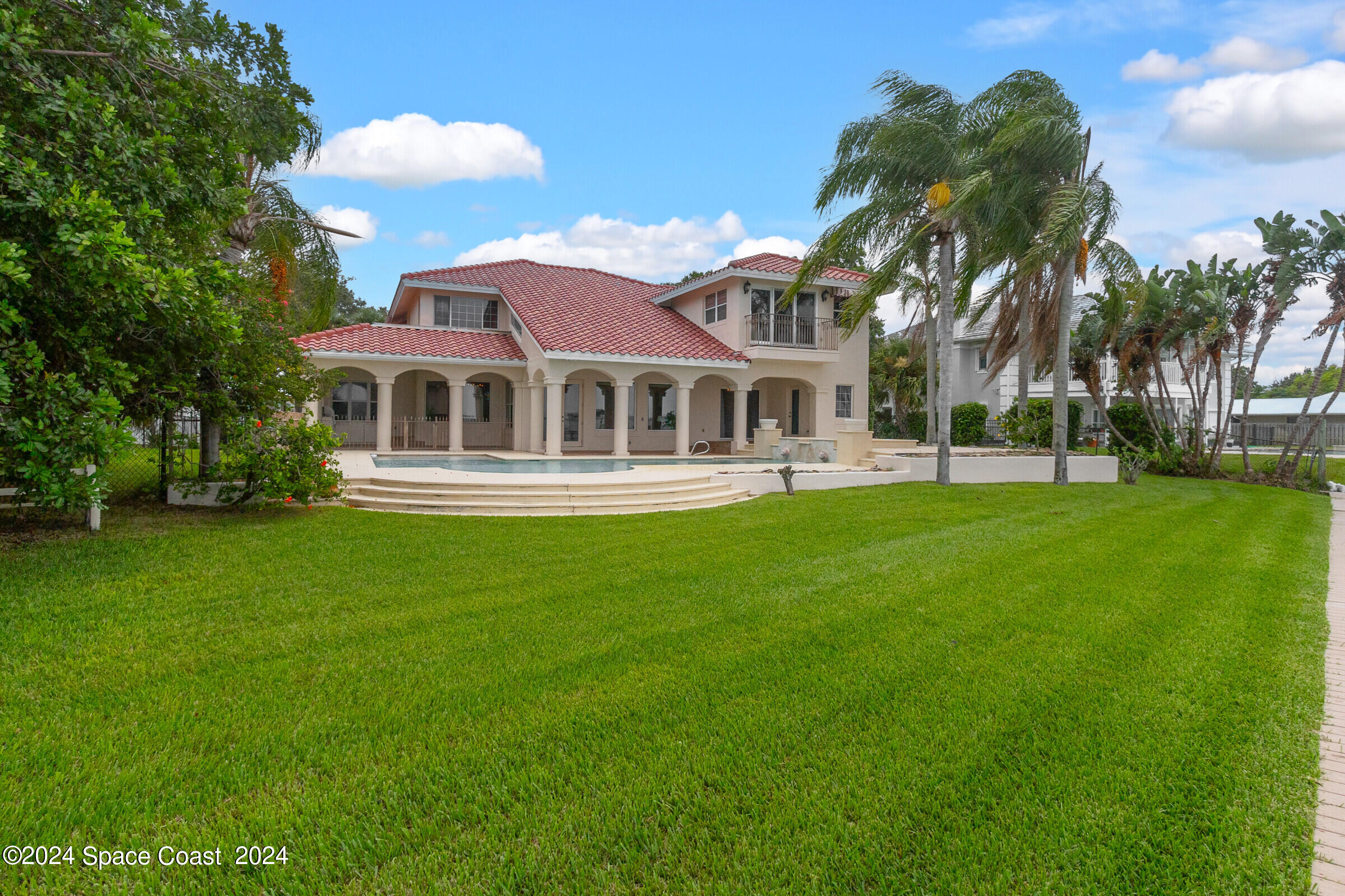 1630 Pine Street Melbourne Beach, FL 32951 - Photo 6 of 54 a front view of a house with a garden
