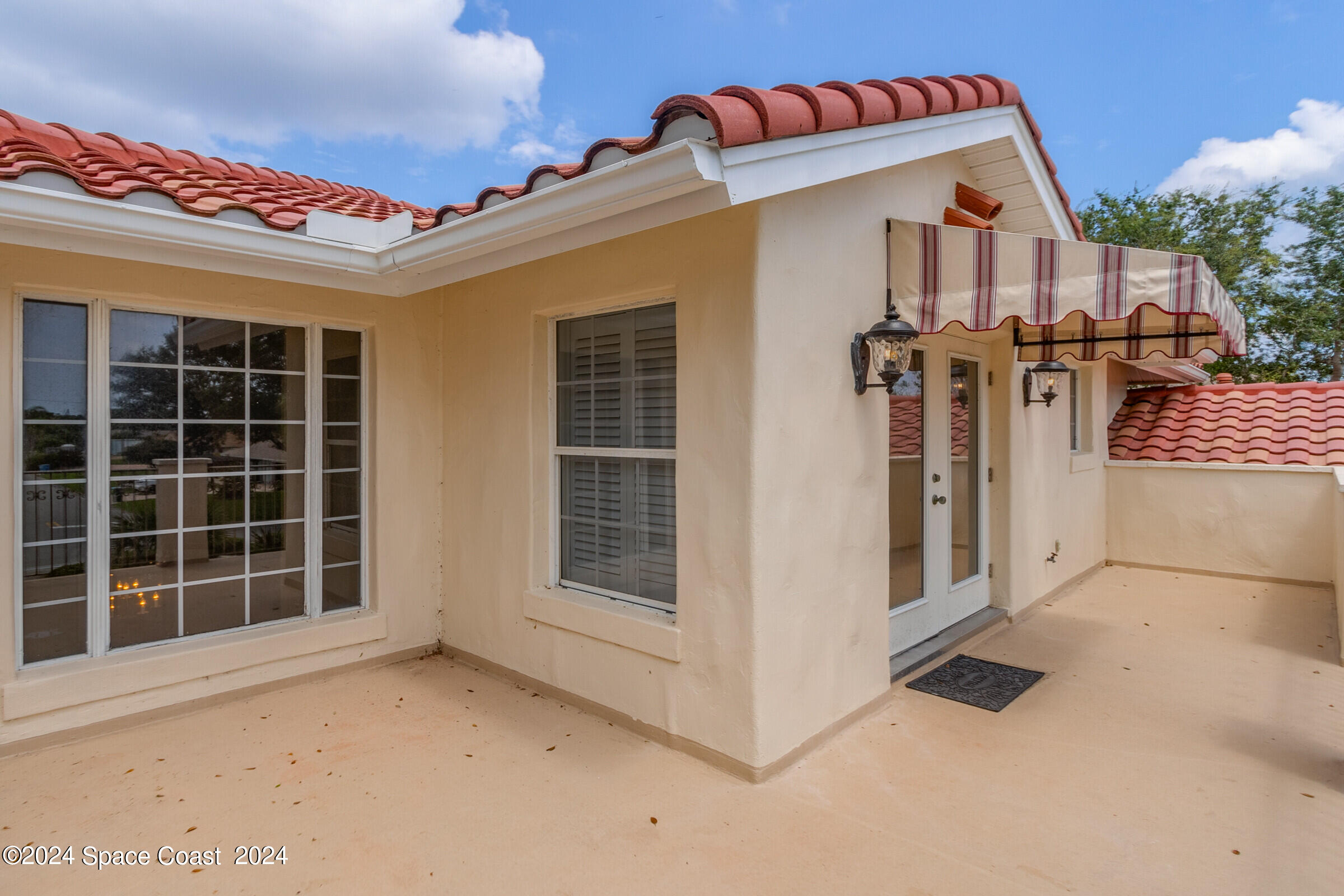 1630 Pine Street Melbourne Beach, FL 32951 - Photo 10 of 54 a front view of a house with a garage