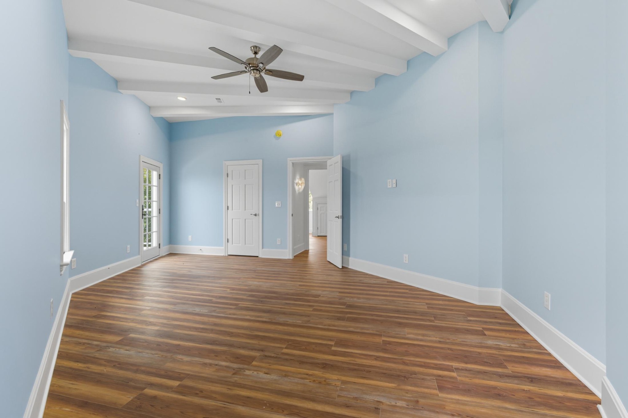 583 Bell Point Road Laceys Spring, AL 35754 - Photo 28 of 50 a view of an empty room with wooden floor and a ceiling fan
