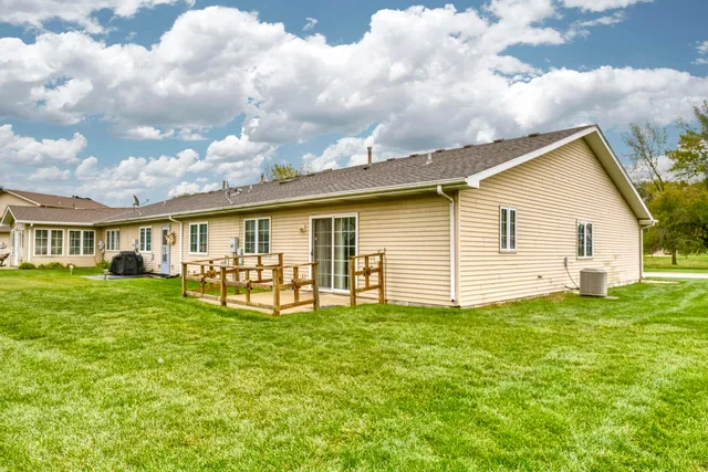 a backyard of a house with table and chairs
