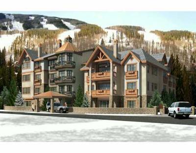 a front view of a residential apartment building with a yard