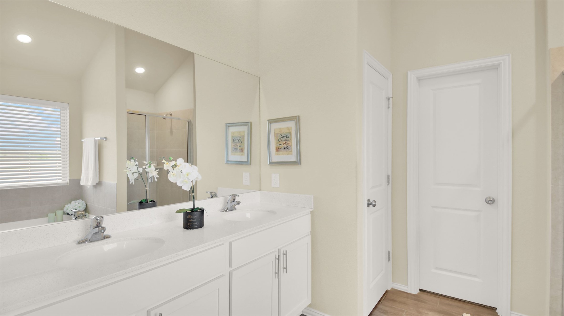 13716 Sugar Bush Path Manor, TX 78653 - Photo 36 of 37 Bathroom with double vanity, a shower stall, and light wood finished floors