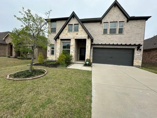 a front view of a house with a yard garage and outdoor seating