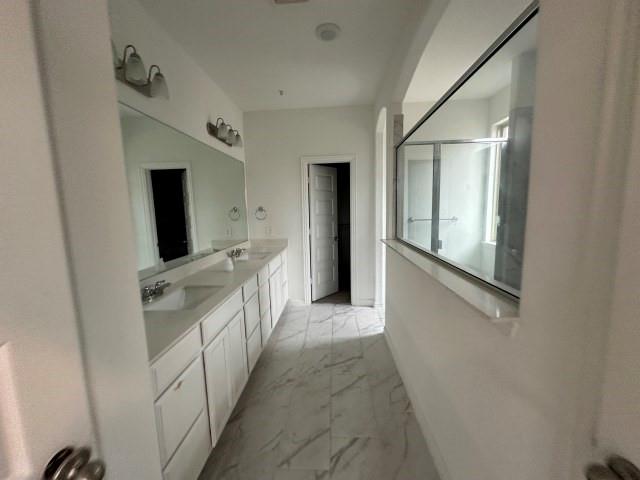 1307 Wheelwright Drive Forney, TX 75126 - Photo 15 of 25 a bathroom with a double vanity sink and mirror