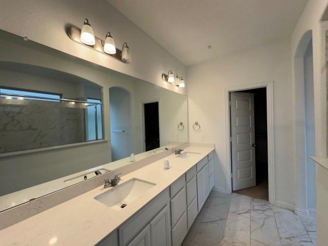 1307 Wheelwright Drive Forney, TX 75126 - Photo 16 of 25 a spacious bathroom with a double vanity sink and a mirror