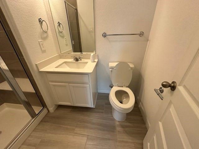1307 Wheelwright Drive Forney, TX 75126 - Photo 18 of 25 a bathroom with a sink a toilet and a mirror