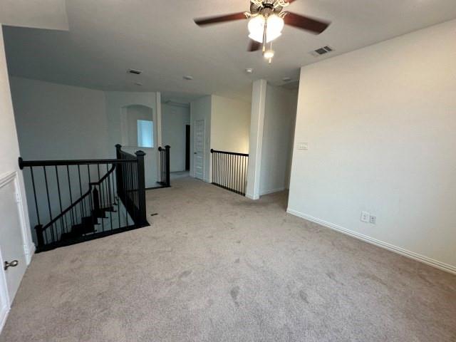 1307 Wheelwright Drive Forney, TX 75126 - Photo 19 of 25 an empty room with chandelier fan and windows