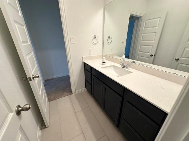 1307 Wheelwright Drive Forney, TX 75126 - Photo 25 of 25 a bathroom with a sink a mirror and a toilet