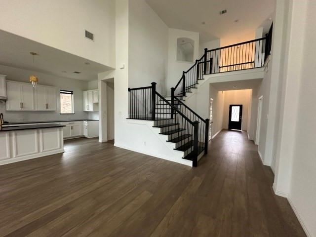 1307 Wheelwright Drive Forney, TX 75126 - Photo 6 of 25 a view of a hallway with wooden floor and a kitchen view