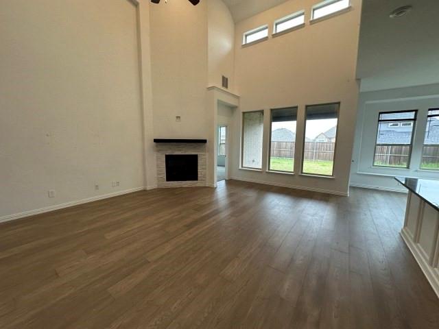 1307 Wheelwright Drive Forney, TX 75126 - Photo 8 of 25 an empty room with wooden floor and fireplace