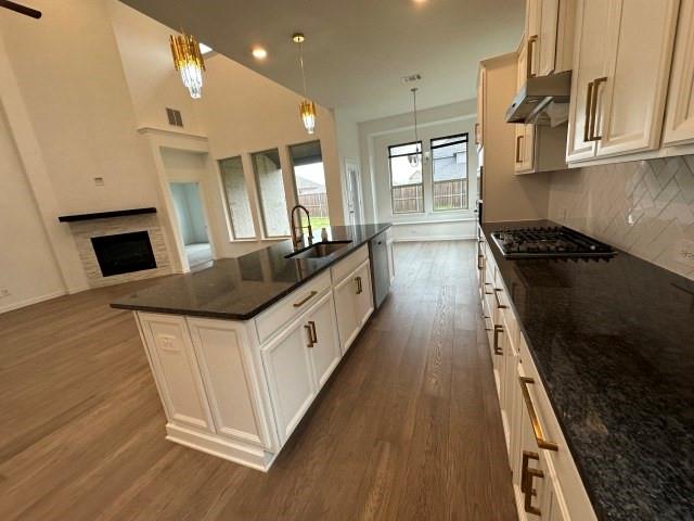 1307 Wheelwright Drive Forney, TX 75126 - Photo 9 of 25 a kitchen with stainless steel appliances a stove a sink a microwave oven and a refrigerator