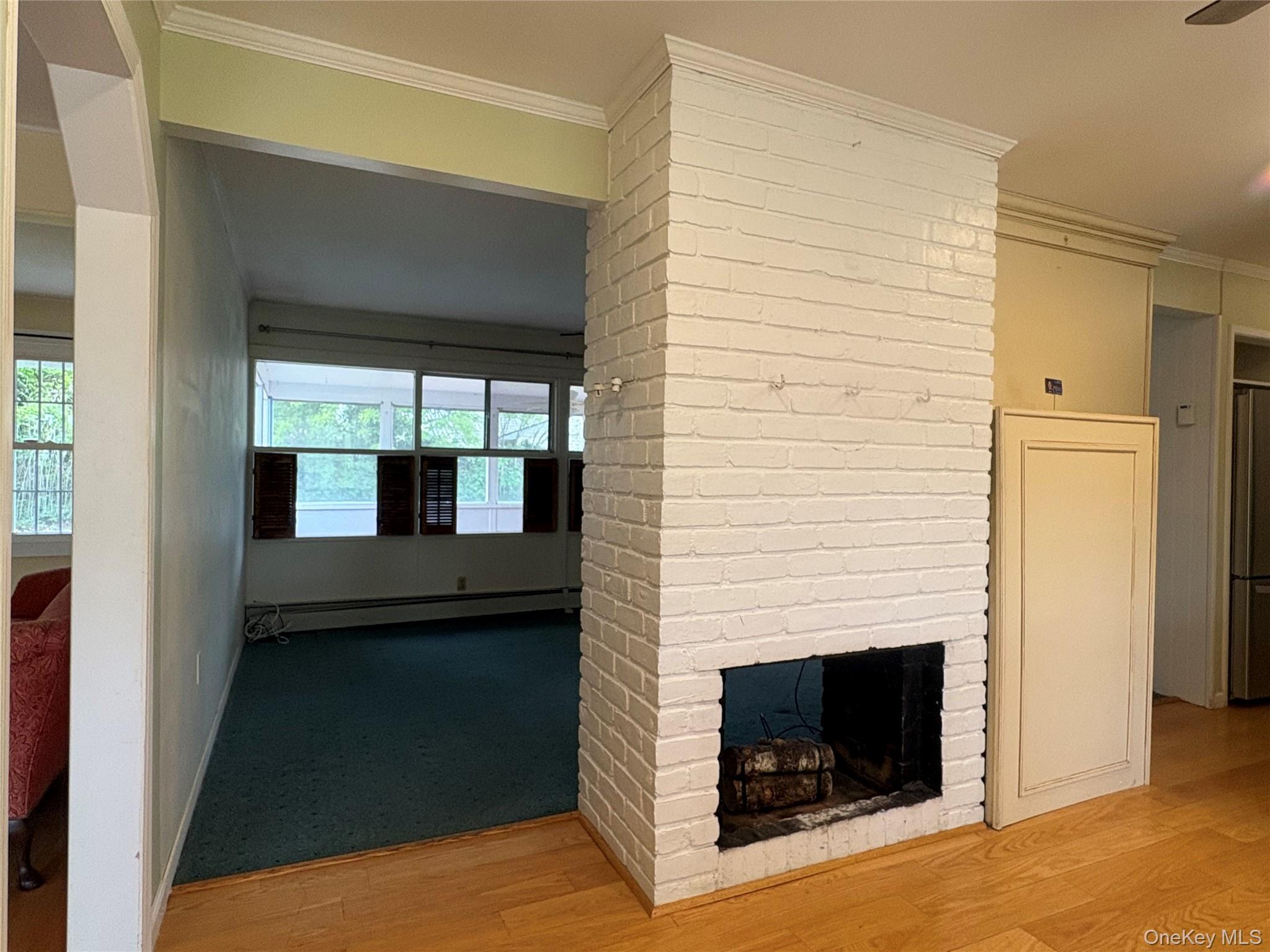 2 Dwarf Lane Wantagh, NY 11793 - Photo 15 of 22 Kitchen and den shared Wood burning fireplace