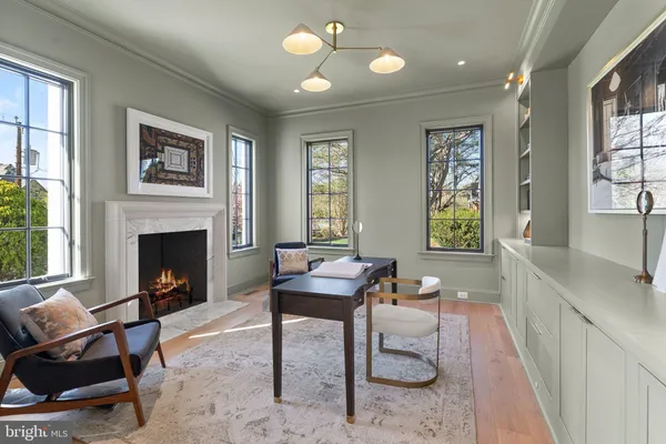 a living room with furniture mirror and fireplace
