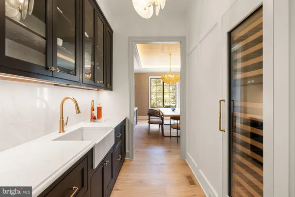 a kitchen with stainless steel appliances granite countertop a sink a stove a refrigerator and a oven with wooden floor