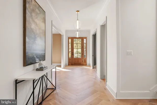 a view of a hallway with wooden floor and entryway