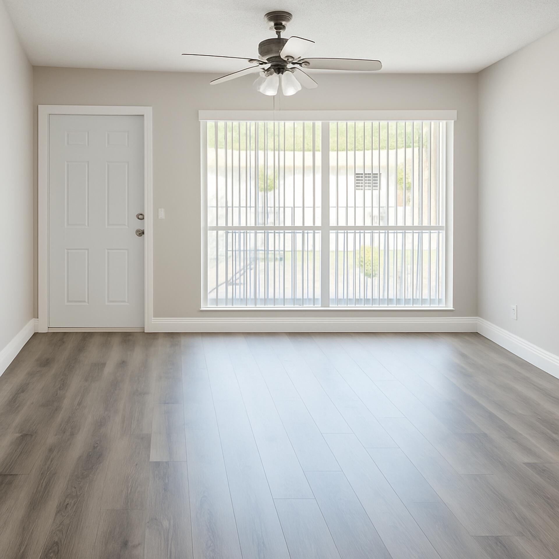 4850 Northeast 5th Avenue, Unit 110 Boca Raton, FL 33431 - Photo 13 of 13 an empty room with wooden floor fan and windows