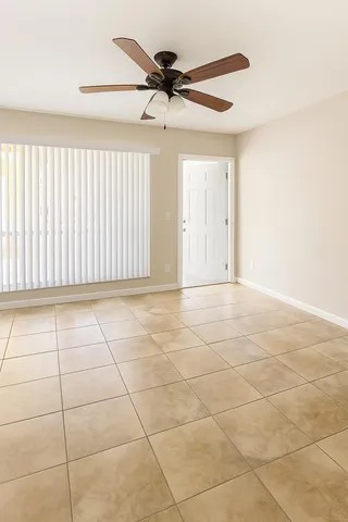 a view of a livingroom with a ceiling fan and window