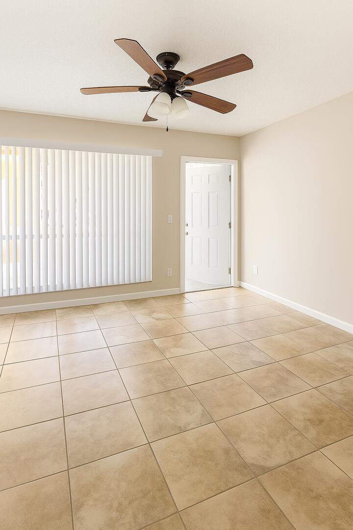 4850 Northeast 5th Avenue, Unit 110 Boca Raton, FL 33431 - Photo 3 of 13 a view of a livingroom with a ceiling fan and window