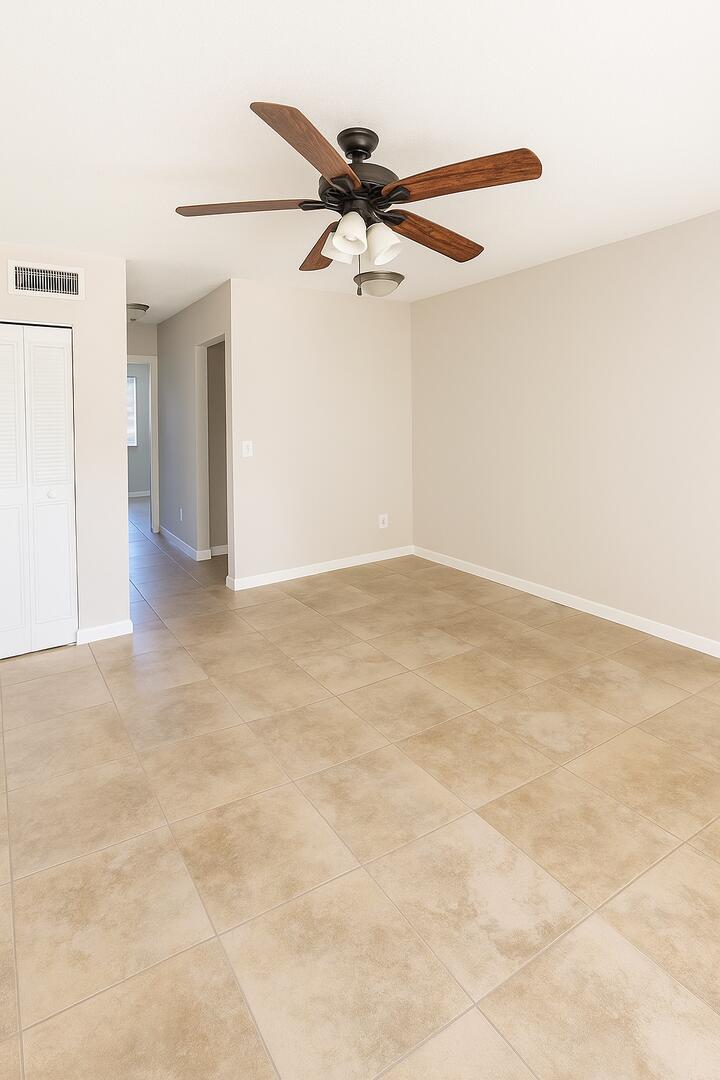 4850 Northeast 5th Avenue, Unit 110 Boca Raton, FL 33431 - Photo 4 of 13 an empty room with a ceiling fan and a window