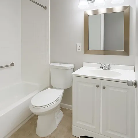 a white toilet sitting next to a bathroom sink