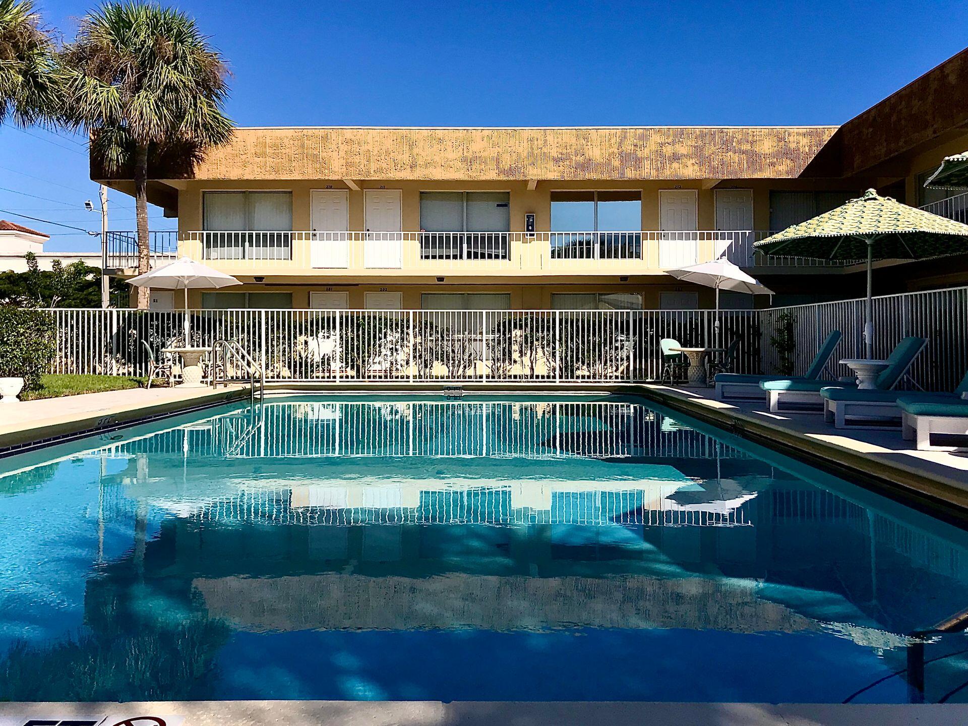 4850 Northeast 5th Avenue, Unit 110 Boca Raton, FL 33431 - Photo 9 of 13 a view of a swimming pool with a patio