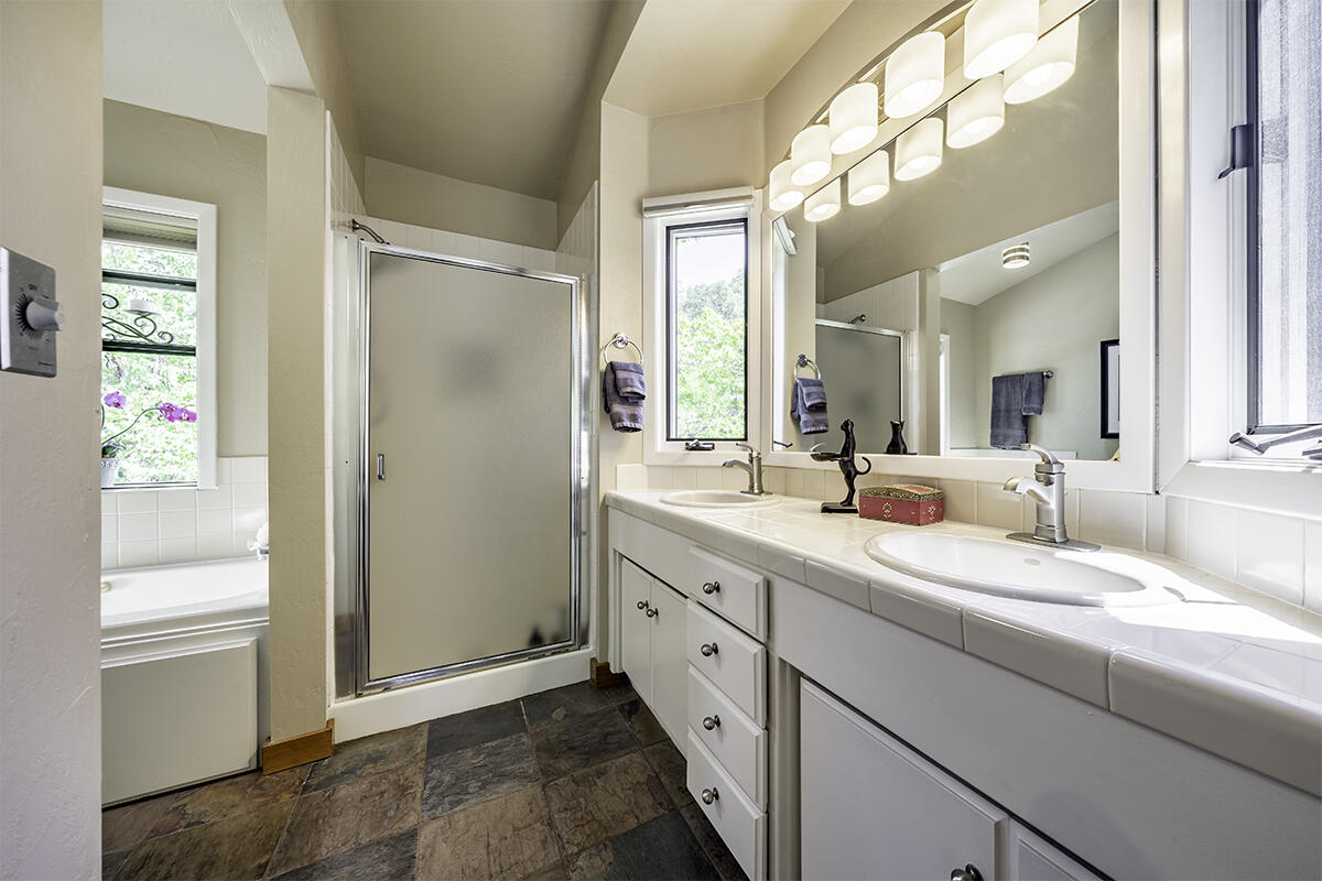 7785 Old Stage Road Central Point, OR 97502 - Photo 17 of 47 a bathroom with a double vanity sink mirror and shower