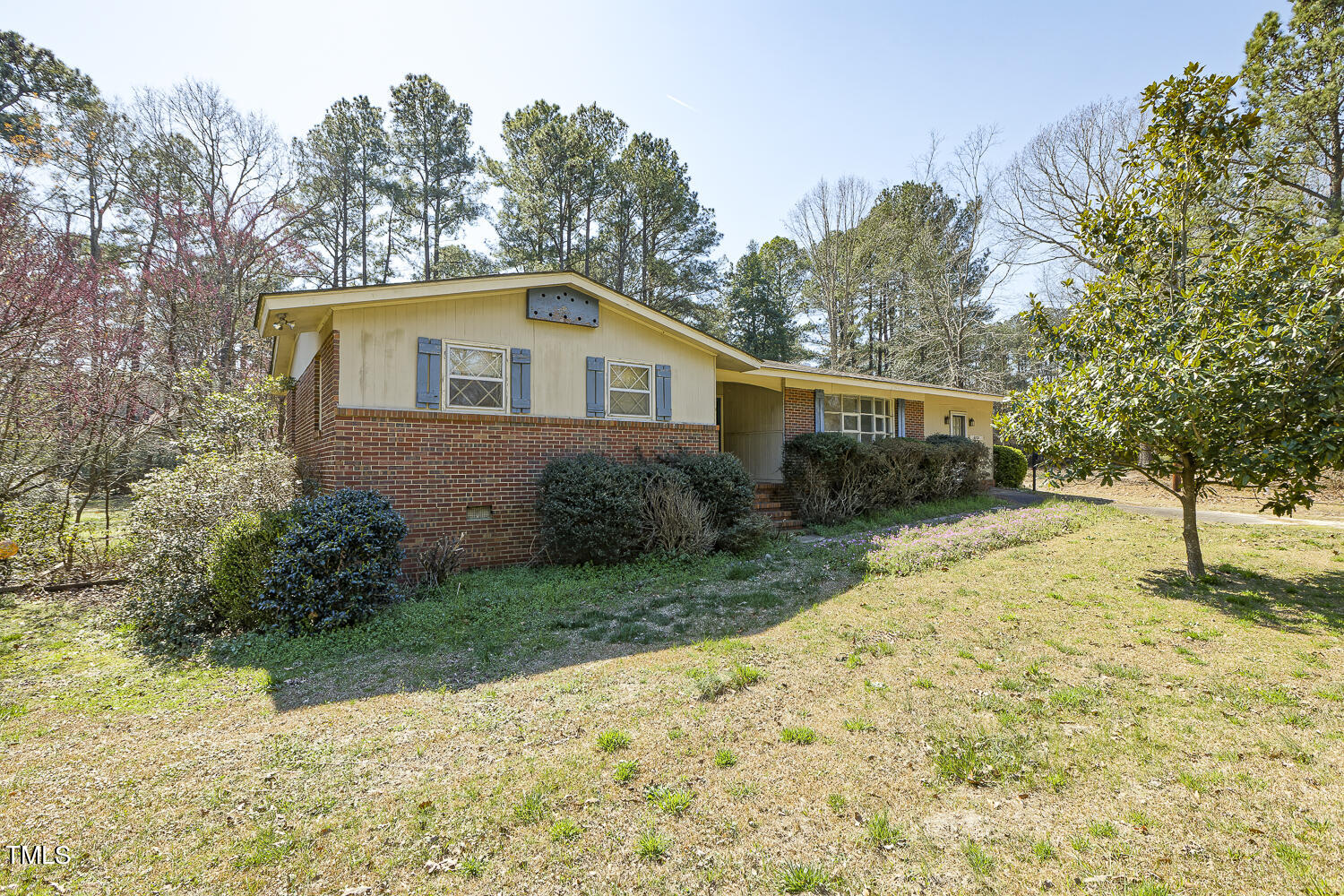 6320 Buffaloe Road Raleigh, NC 27604 - Photo 1 of 50 a front view of a house with a yard and trees