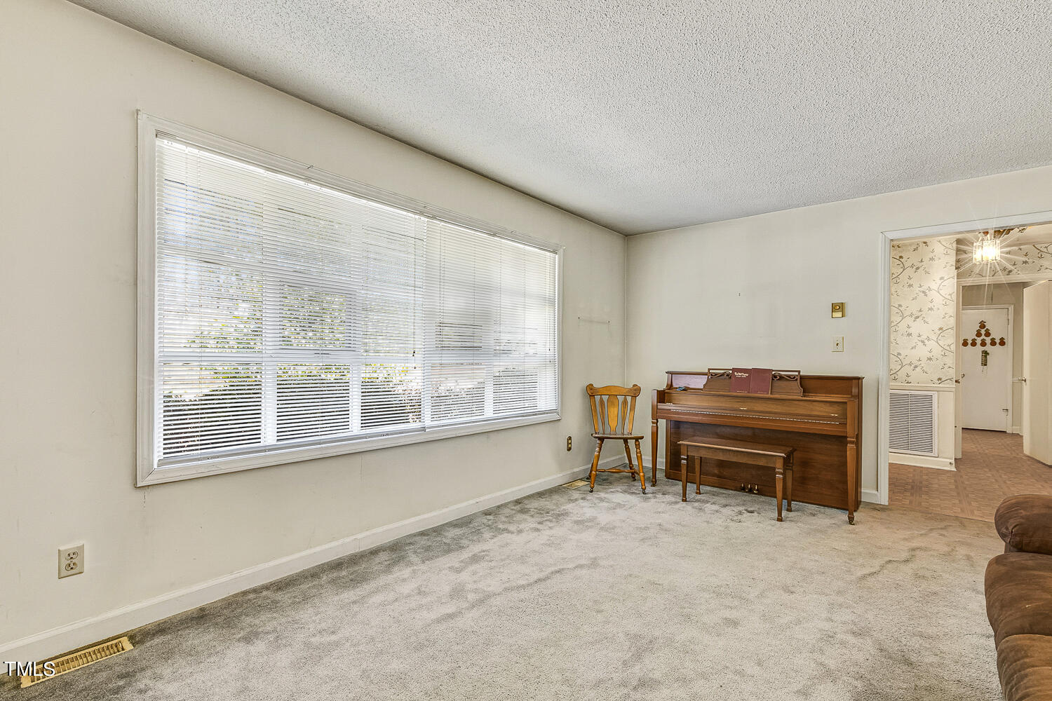 6320 Buffaloe Road Raleigh, NC 27604 - Photo 13 of 50 a living room with a piano table and a large window