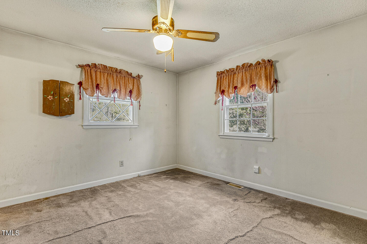 6320 Buffaloe Road Raleigh, NC 27604 - Photo 29 of 50 an empty room with windows and fan