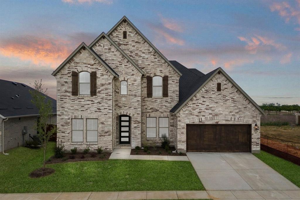 1124 Hitching Post Way Oak Point, TX 75068 - Photo 1 of 34 a front view of a house with a garden and yard