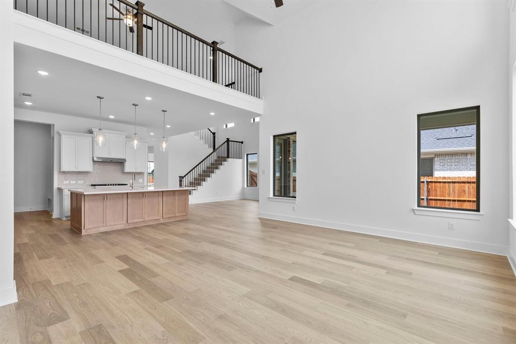 1124 Hitching Post Way Oak Point, TX 75068 - Photo 25 of 34 a view of a kitchen with a sink and a living room